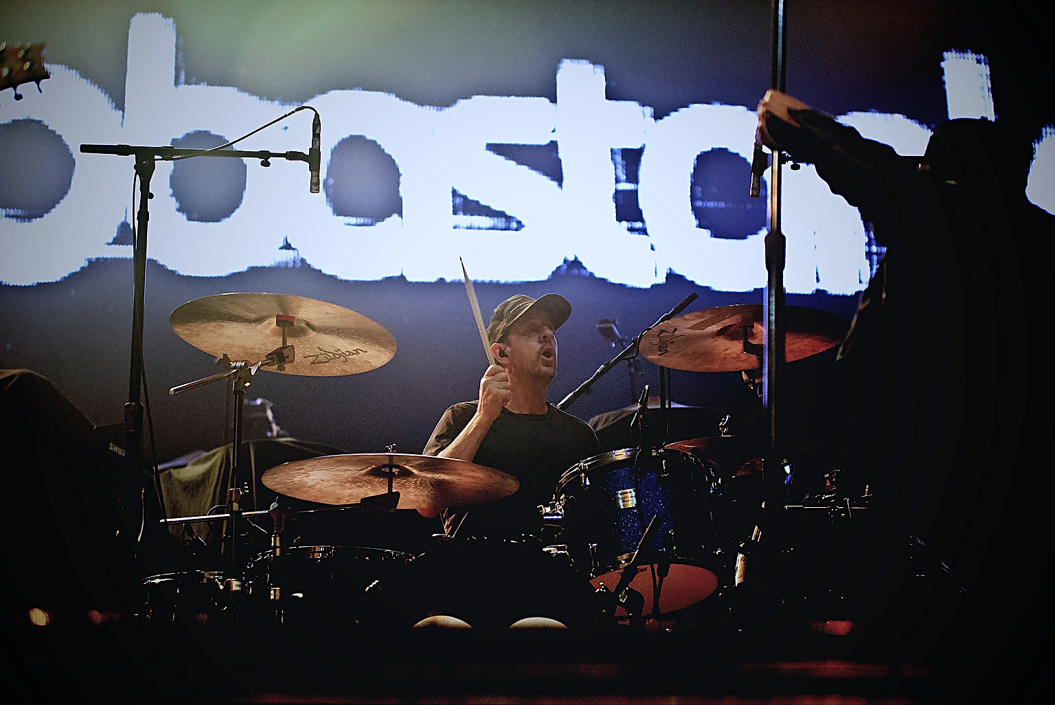 Hoobastank drummer playing beneath the Hoobastank logo backdrop at Toyota Arena, Ontario, California