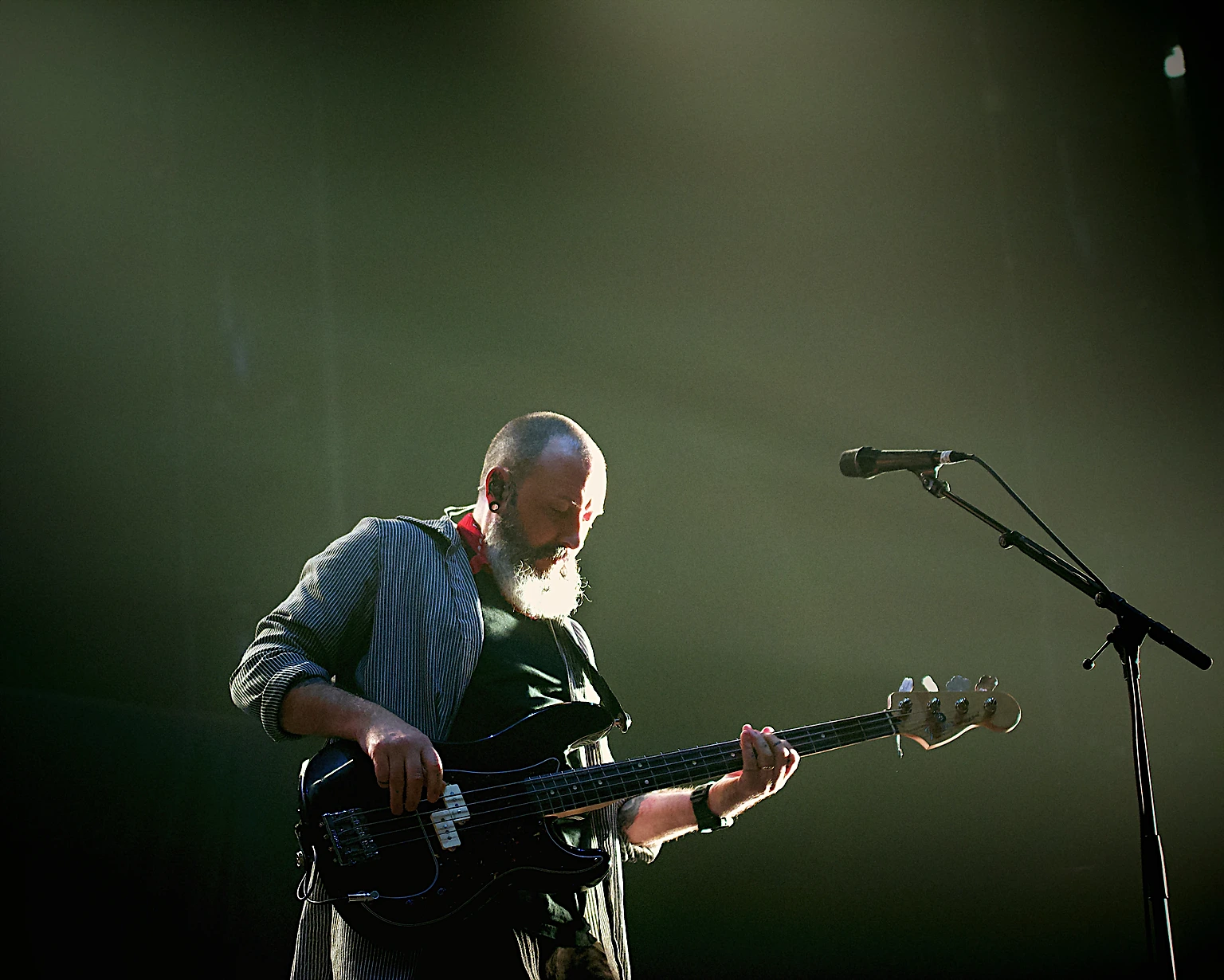 Hoobastank bassist playing under green stage light at Toyota Arena, Ontario