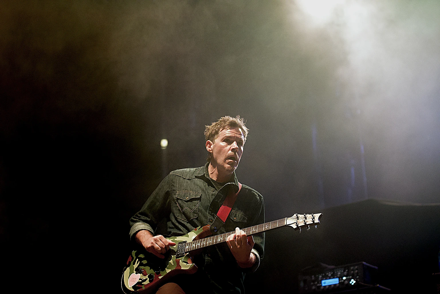 Hoobastank guitarist under a haze-filled spotlight at Toyota Arena, Ontario