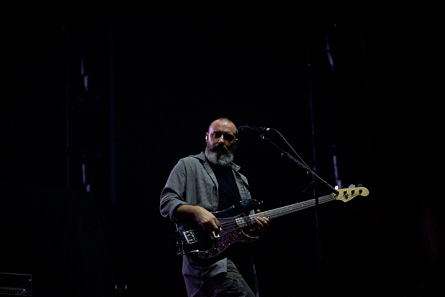 Hoobastank bassist alone in a single spotlight at Toyota Arena, Ontario