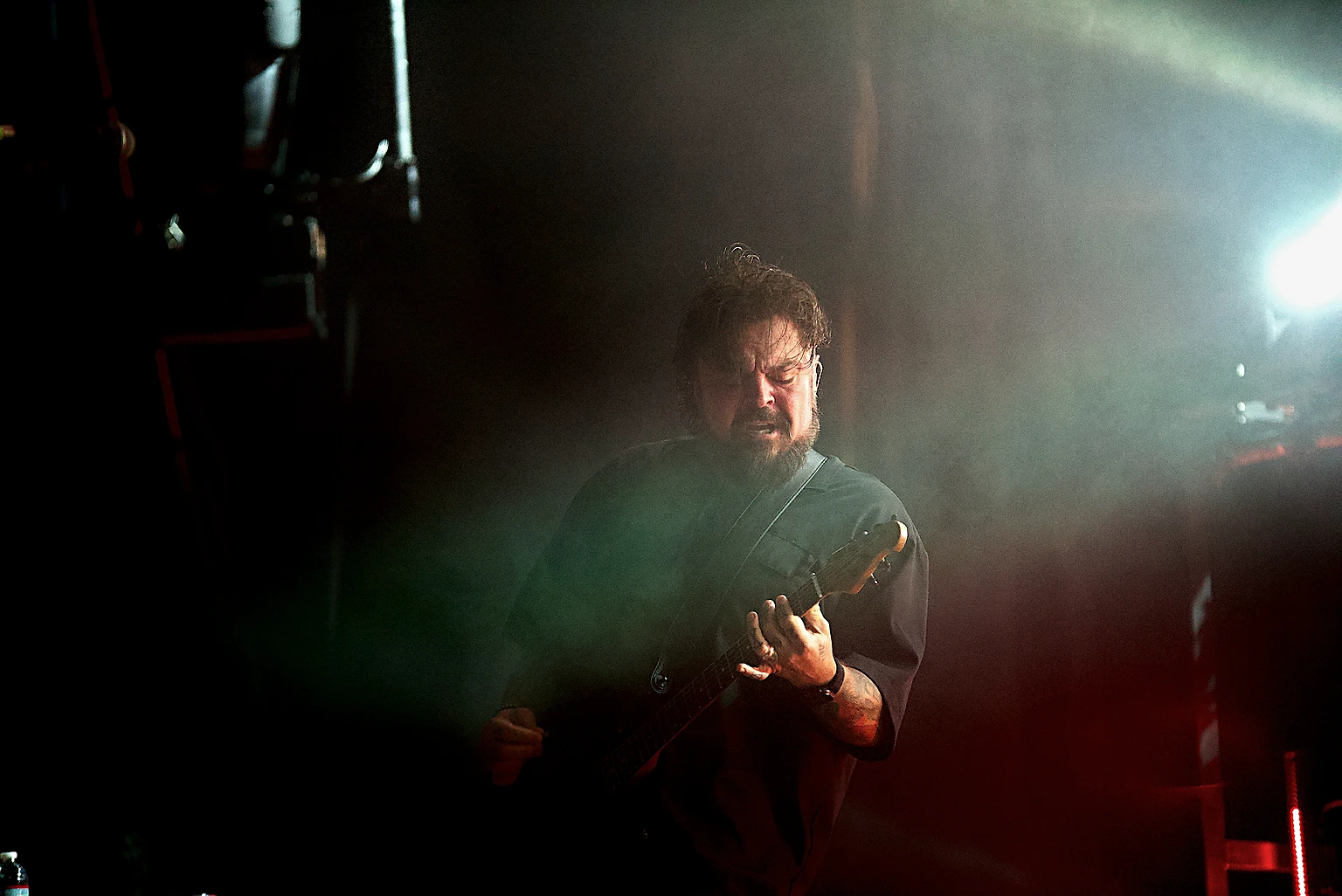 Seether guitarist playing in green light and stage haze at Toyota Arena, Ontario