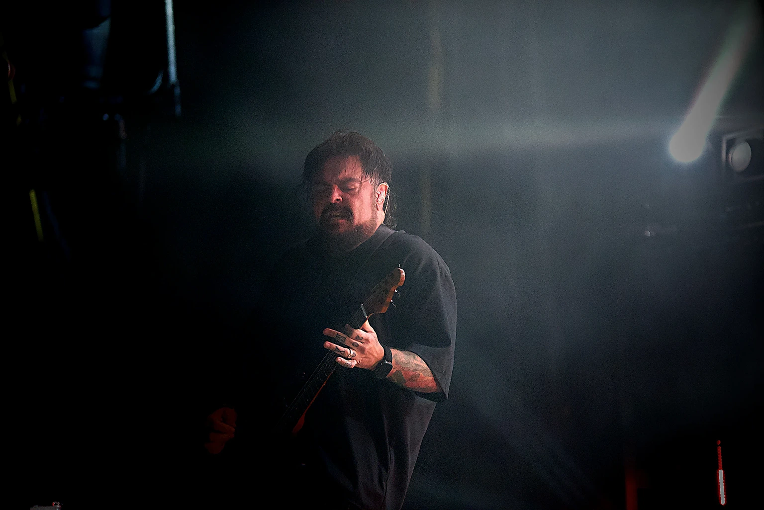 Seether guitarist under stage light beams at Toyota Arena, Ontario