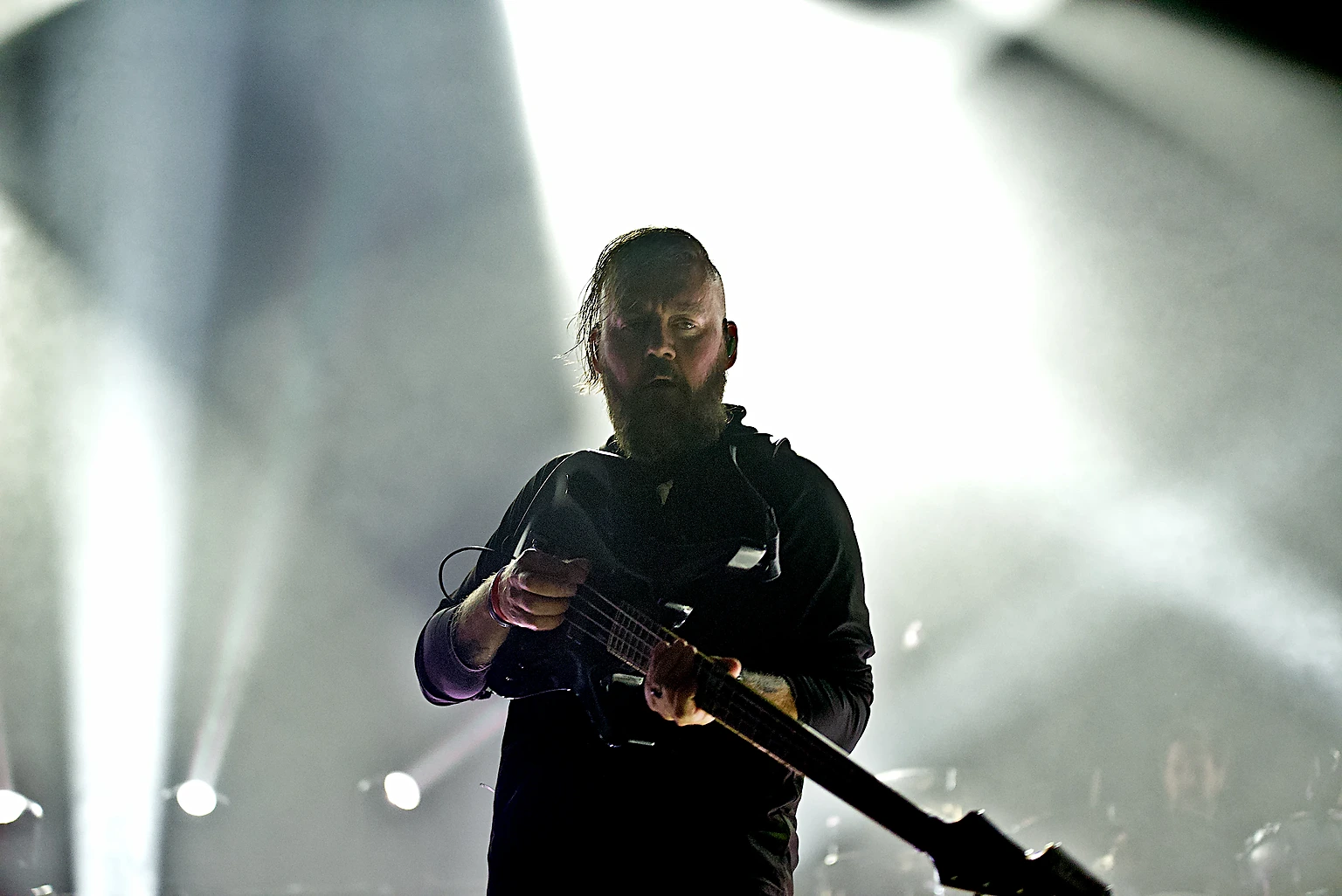 Seether bassist backlit by white stage lights at Toyota Arena, Ontario