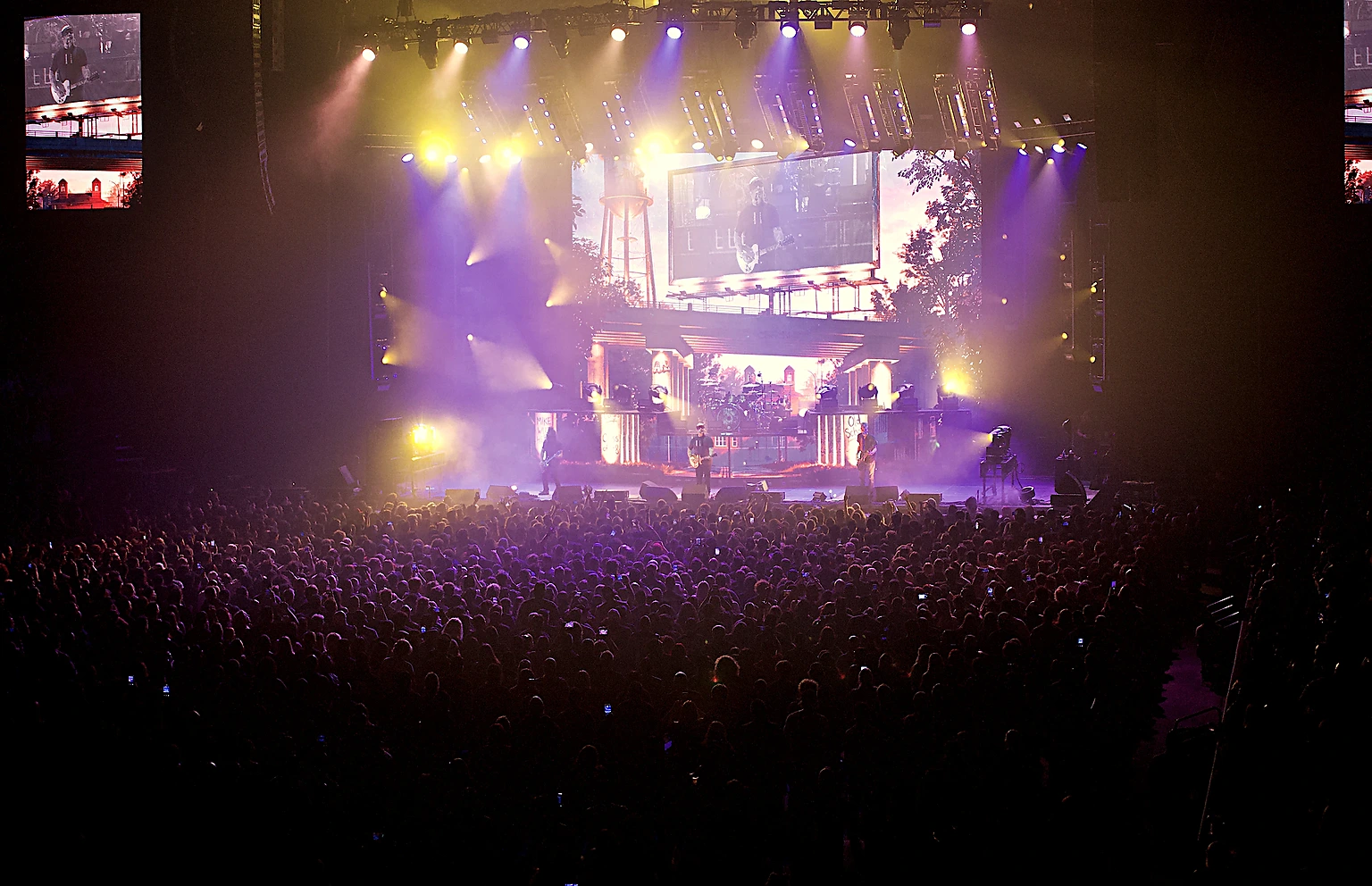 Wide view of Staind on stage with lights and screens over the crowd at Toyota Arena, Ontario